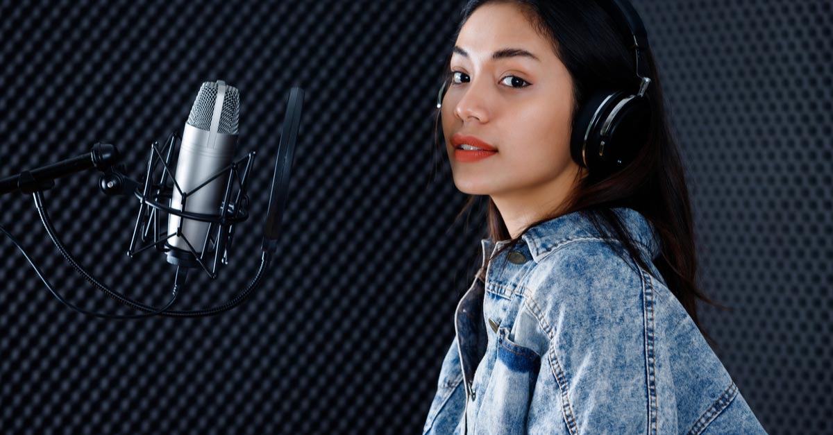 Asian female singer in studio with mic