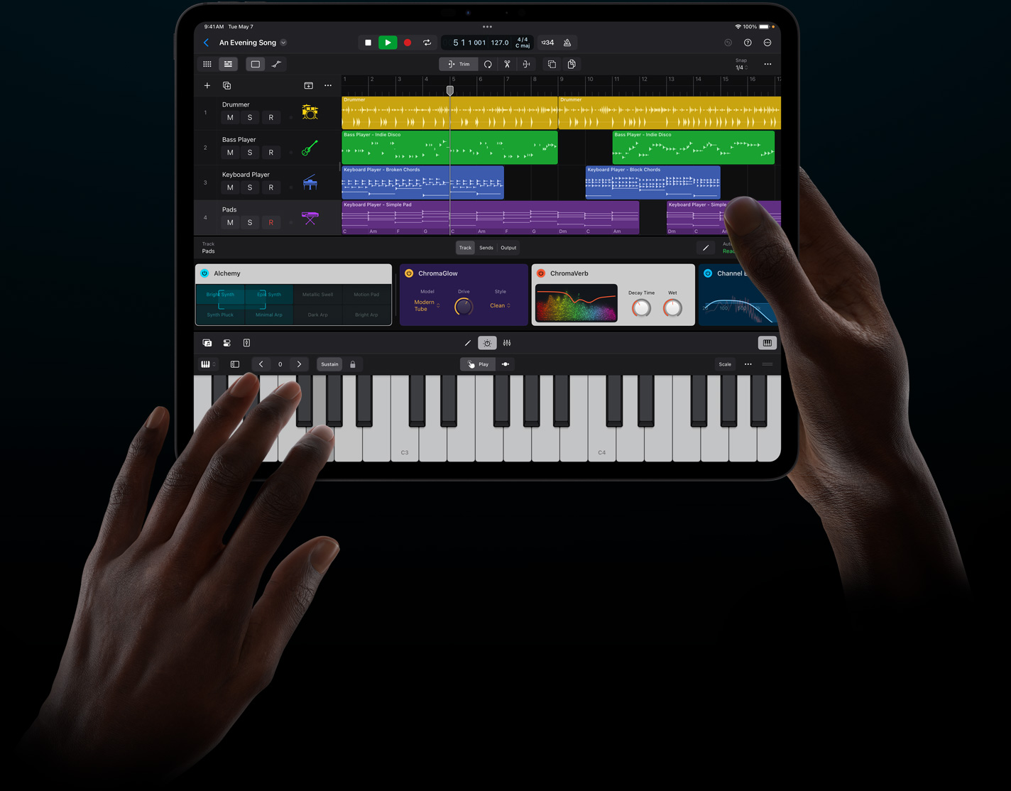 Logic Pro running on an iPad being held by two hands